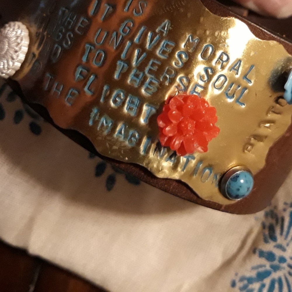 Leather snap closure cuff with Plato quote
